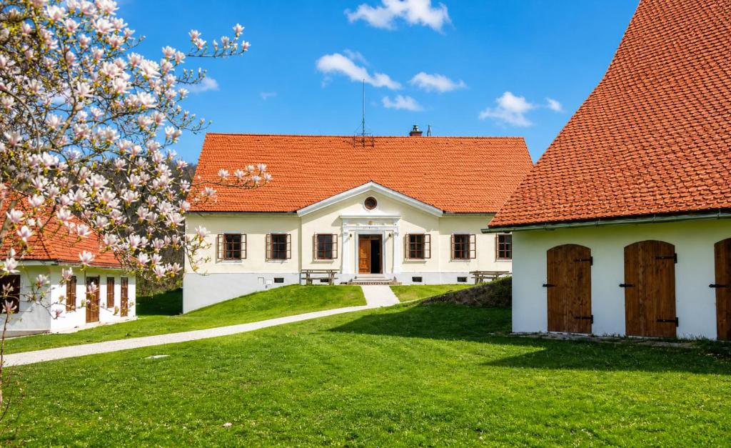 a white house with an orange roof at Rezidenca Korman in Fala