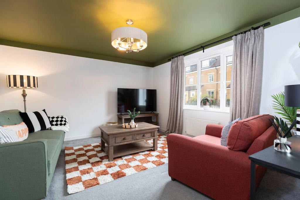 a living room with a couch and a tv at Stylish Durham 3-Bed Comfort Long Stays in Spennymoor