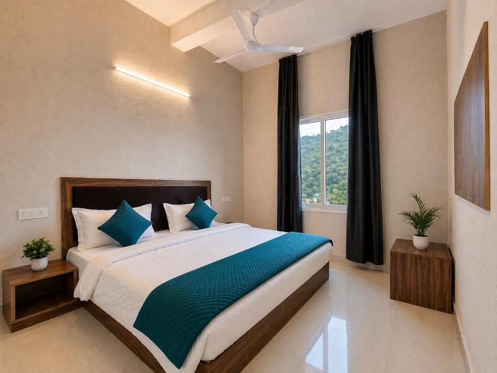 a bedroom with a large bed with a window at Deep Heritage Hotel & Restaurant in Phata