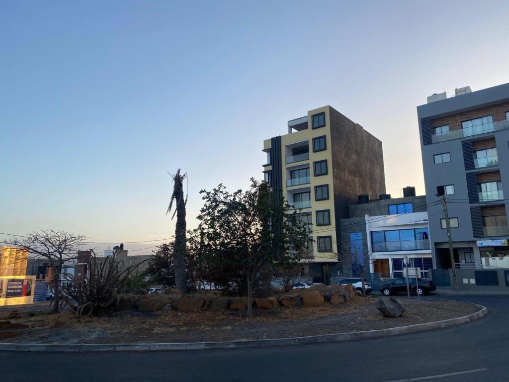 a statue of a cross in the middle of a city at Kevin Island House in Ilhéu de Santa Maria