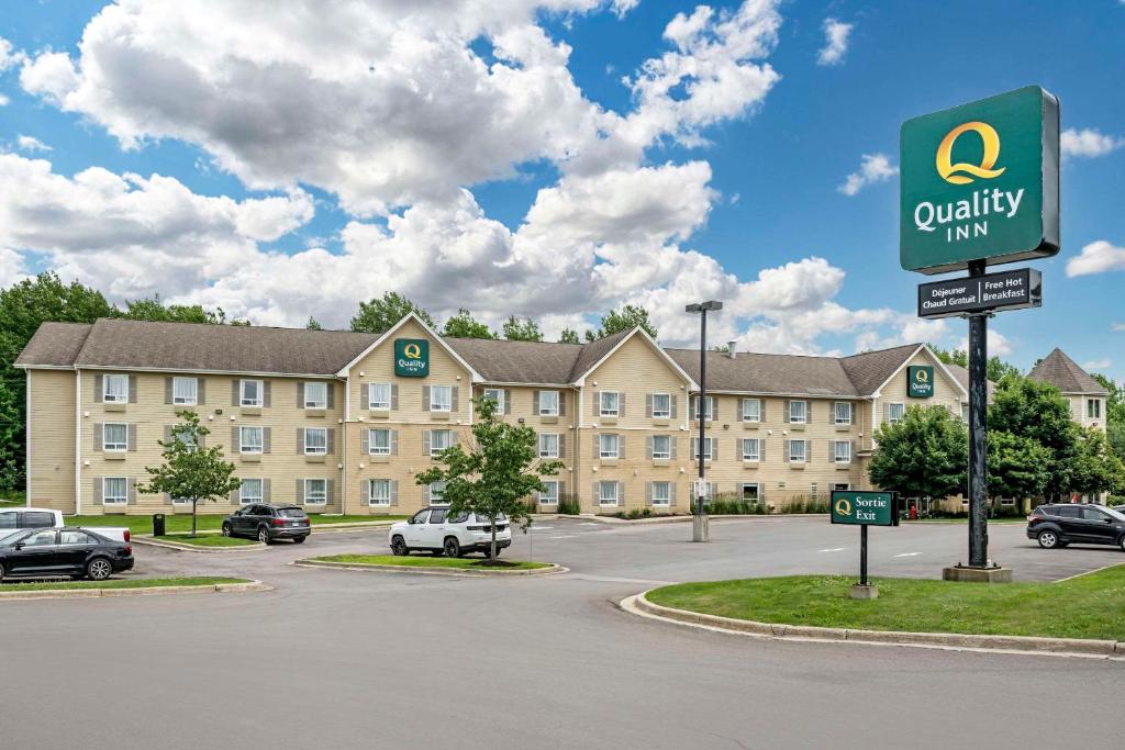 a parking lot in front of a large building at Quality Inn Airport in Moncton