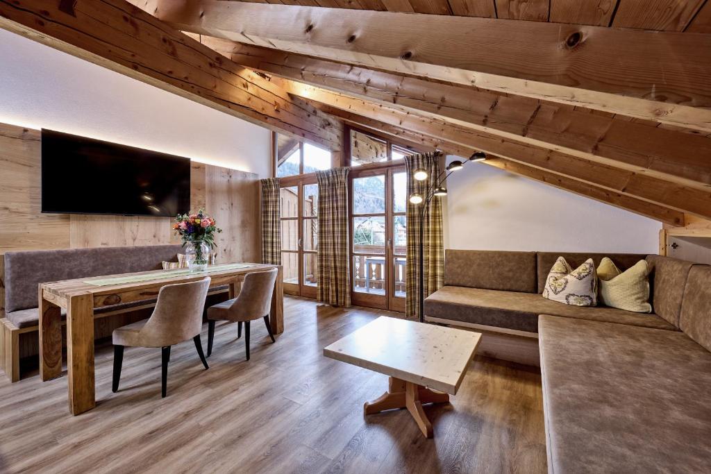 a living room with a couch and a table at Ferienhaus Magdalena in Mittenwald