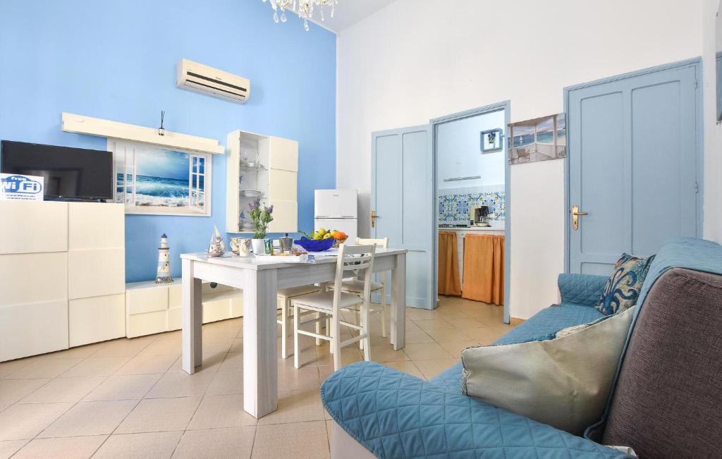a living room with a table and a kitchen at 1 Bedroom Beautiful Apartment In Trappeto in Trappeto