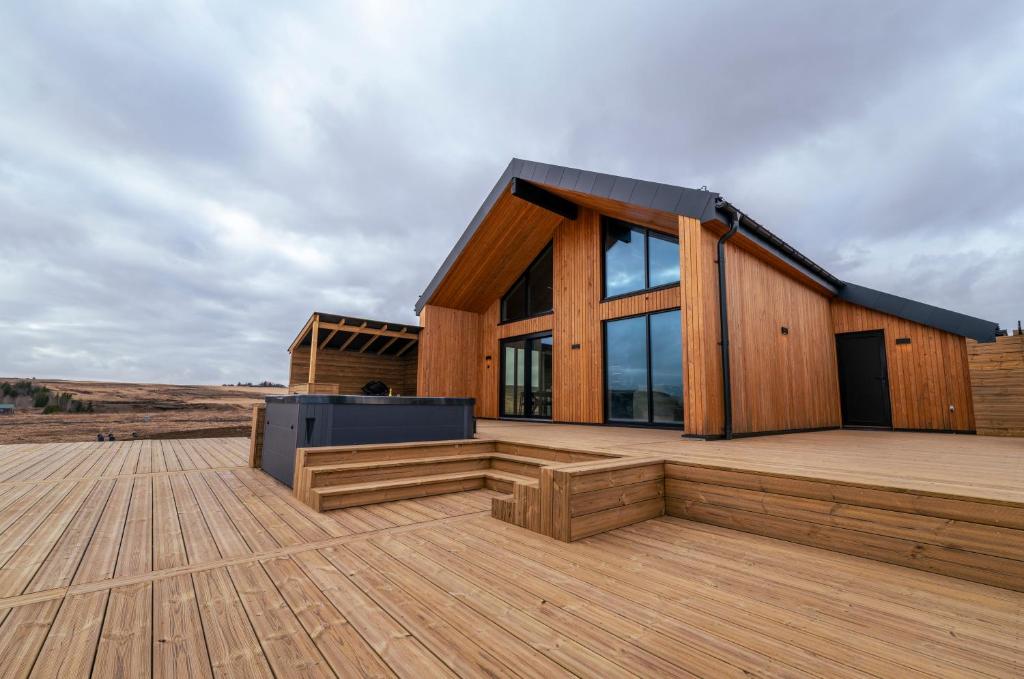 a wooden house on a wooden deck at Modern Aurora Retreat in Selfoss