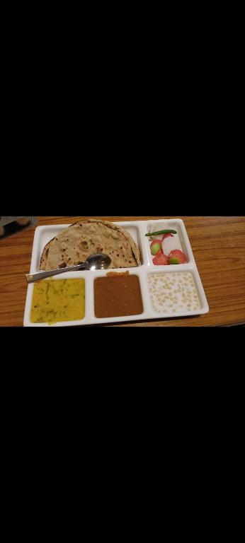 a tray of different types of food on a table at The Mount lakes in Bhīm Tāl