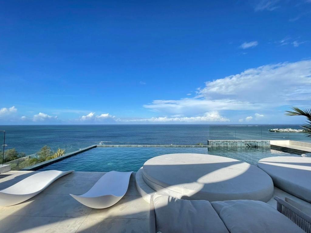 a swimming pool with a view of the ocean at Nyali Evoque - BriSta Stays in Mombasa