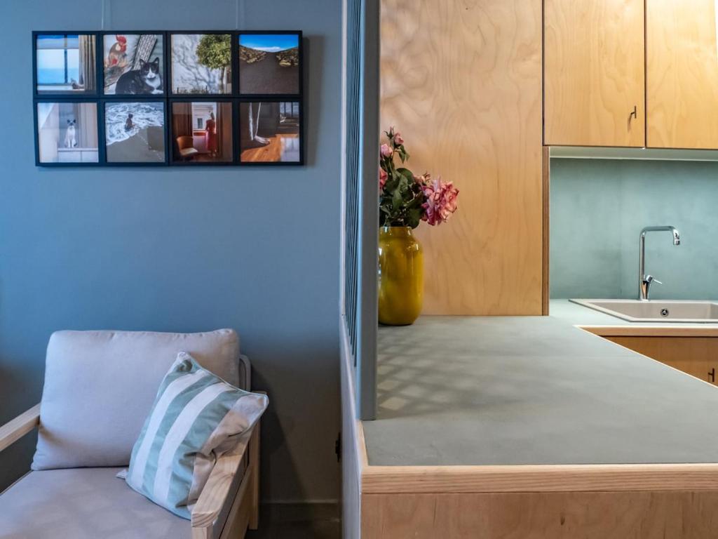 a kitchen with a couch and a counter with a sink at Downtown photographer's studio 2 in Korinthos