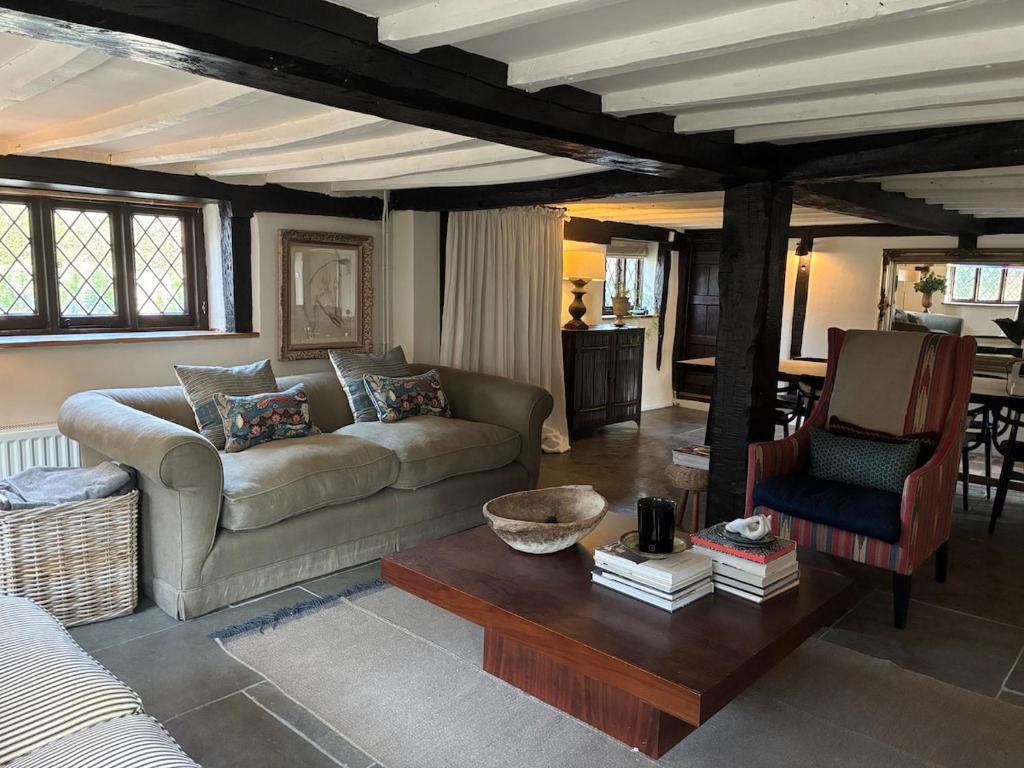 a living room with a couch and a table at Cottage in the Hambleden Valley in Henley on Thames