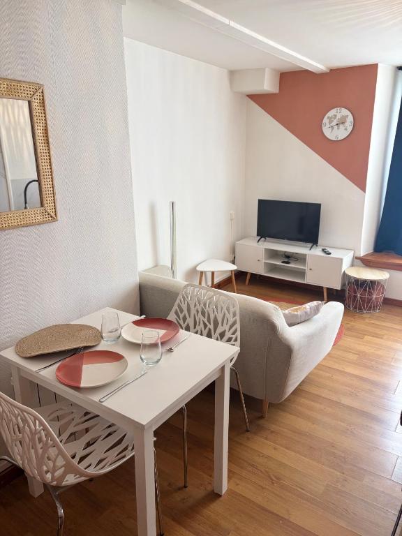 a living room with a table and a couch at Blez kò in Vaucouleurs
