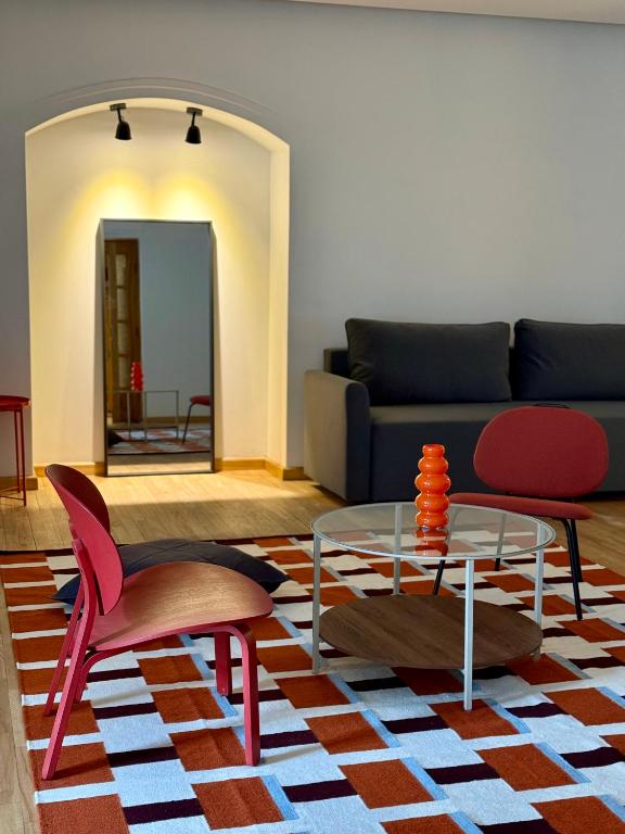 a living room with a couch and a table and chairs at Zema11 Old Town Space in Vilnius