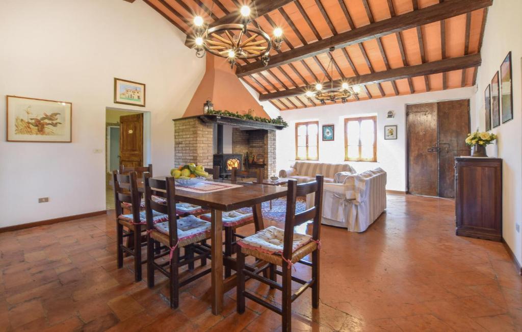 a kitchen and dining room with a table and chairs at Umbria Magione Podere C in Magione
