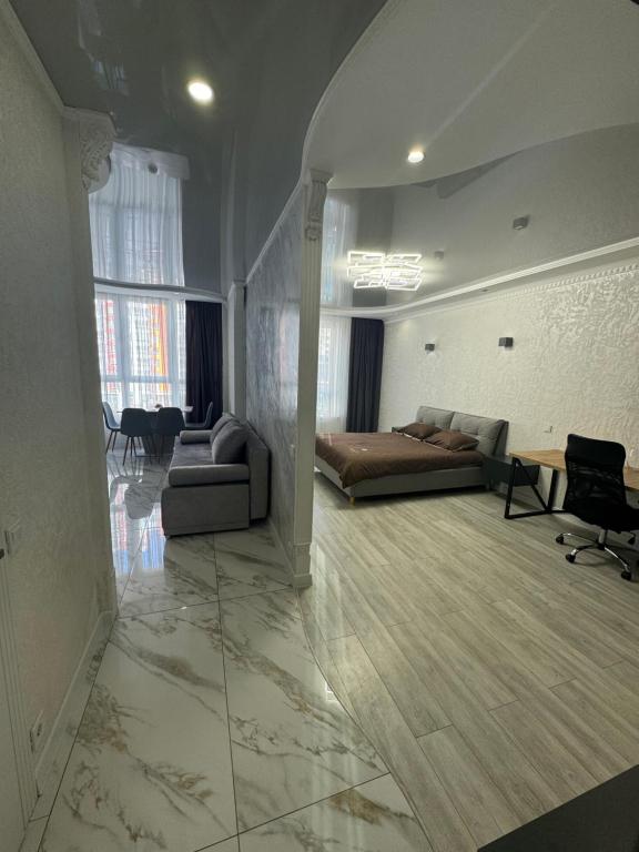 a living room with a couch and a table at ЖК Акварель 2 in Odesa