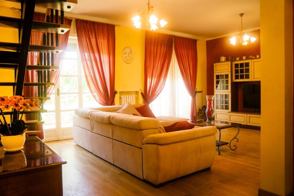 ein Wohnzimmer mit einem weißen Sofa vor einem Fenster in der Unterkunft Sogna&Vola in San Giovanni Teatino