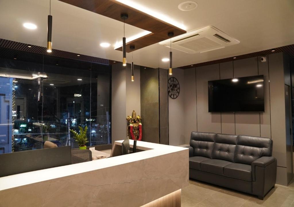 a lobby with a couch and a flat screen tv at Sri Rama Grand in Chilakalūrupet