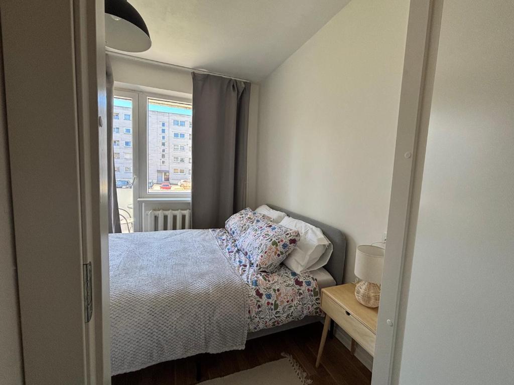 a small bedroom with a bed and a window at Green & Quiet Apartment in Haapsalu in Haapsalu