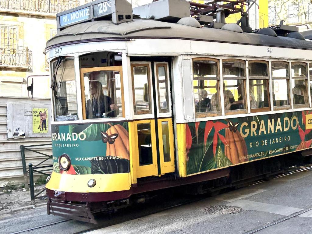 a trolley car with an advertisement on it at Alfama Premium in Lisbon