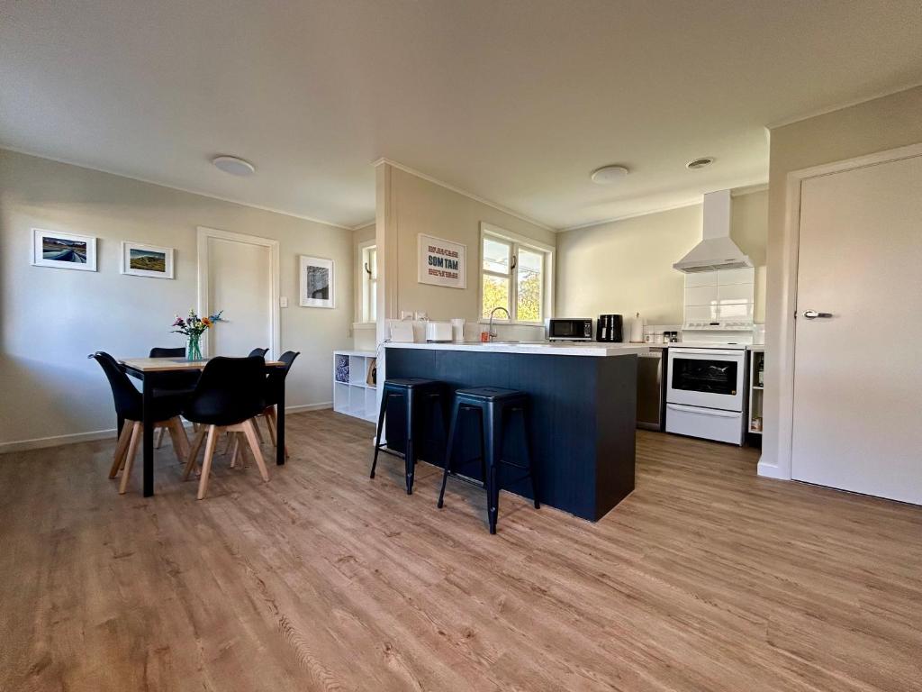 a kitchen and dining room with a table and chairs at Hanmer Time in Hanmer Springs