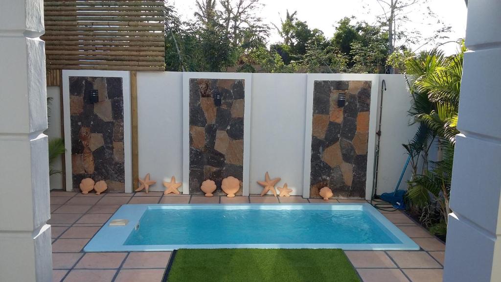 a small swimming pool in a yard with a fence at Trident Villa in Balaclava