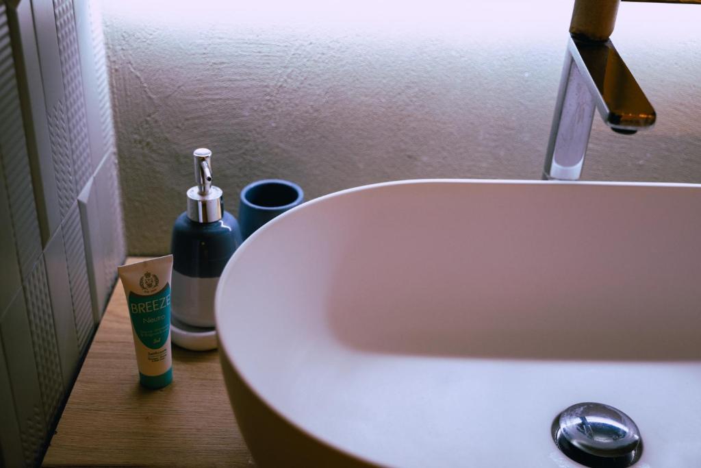 a bathroom sink with a toothbrush and a bottle of toothpaste at Casa Gentile in Conversano