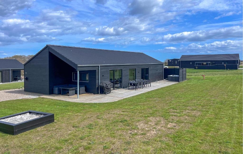 a black building with a grill in a yard at Beautiful Home In Haderslev With Sauna in Haderslev