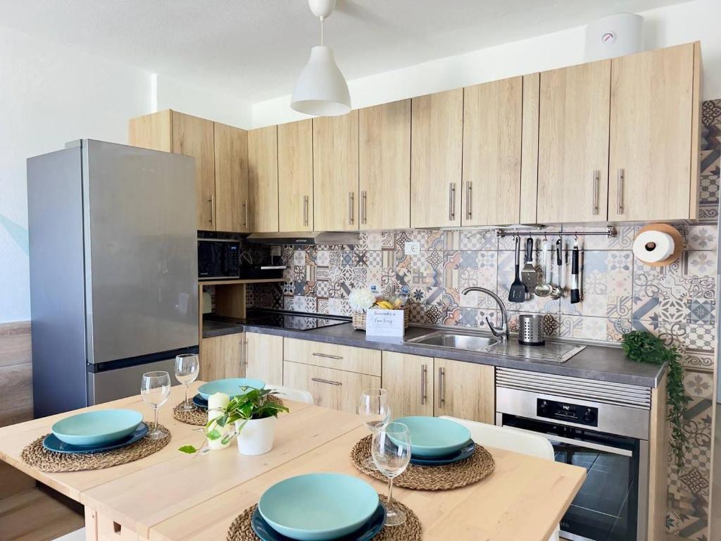 a kitchen with wooden cabinets and blue plates on a table at NextGen Casa Rossy in Antigua