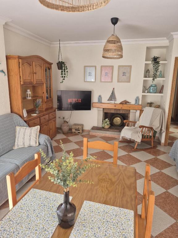 a living room with a couch and a table at Casa Delfin in Punta Umbría