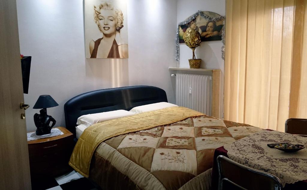 um quarto com uma cama com uma colcha em Alaska Rooms em Verona