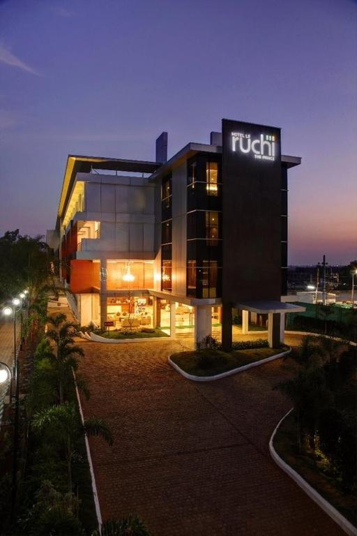 a hotel with a sign on the side of a building at Hotel Le Ruchi The Prince in Mysore