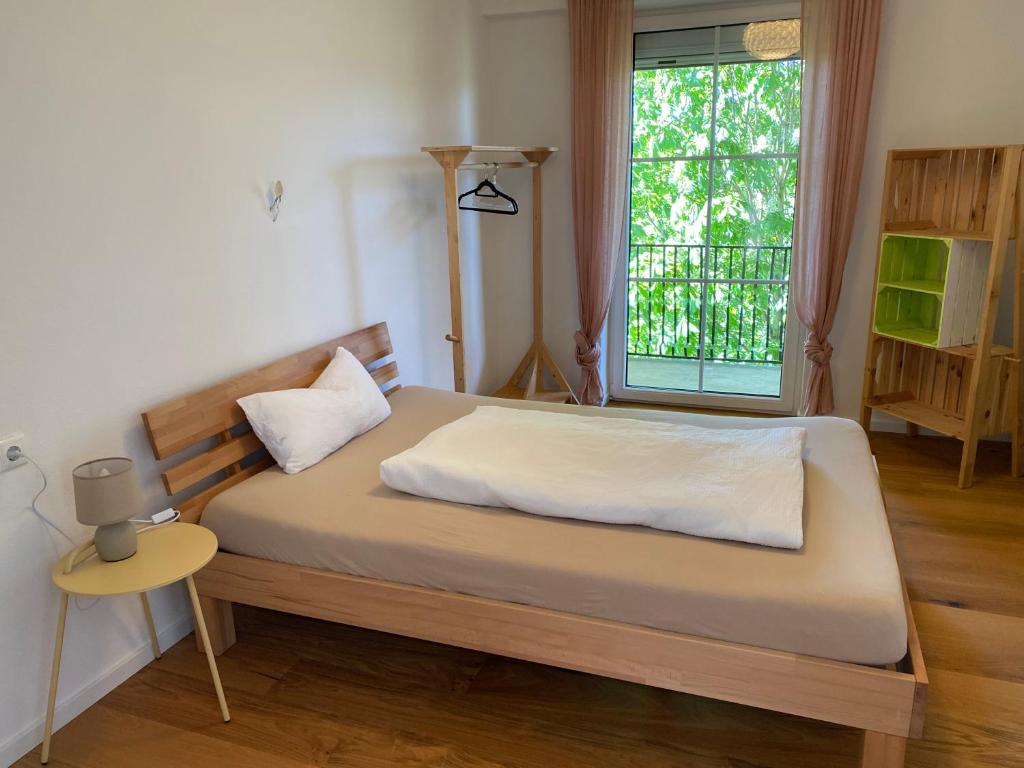 a bedroom with a large bed with a window at Pension Straßl in Andorf