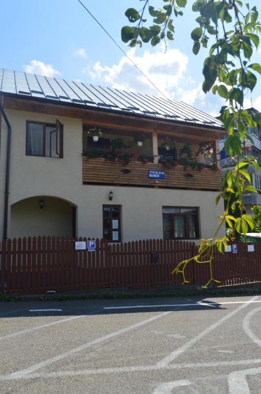 a building with a fence in front of it at Pensiunea Alexa in Durău