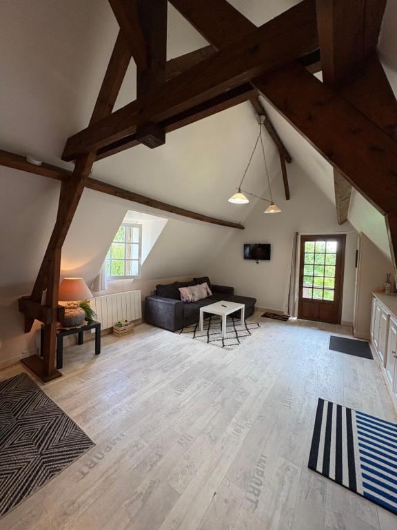 a large living room with a couch and a table at Le Cottage in Cambremer