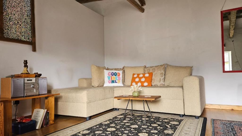 a living room with a couch and a table at Balkan Barn in Tŭzha