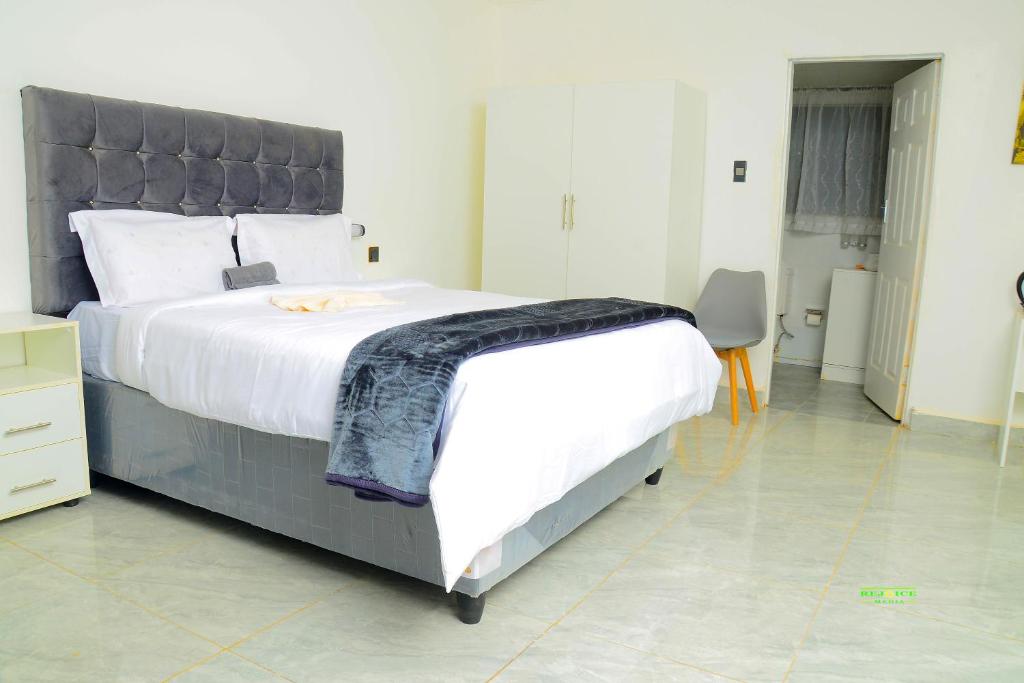 a bedroom with a large bed with a black headboard at On Edward in Bulawayo