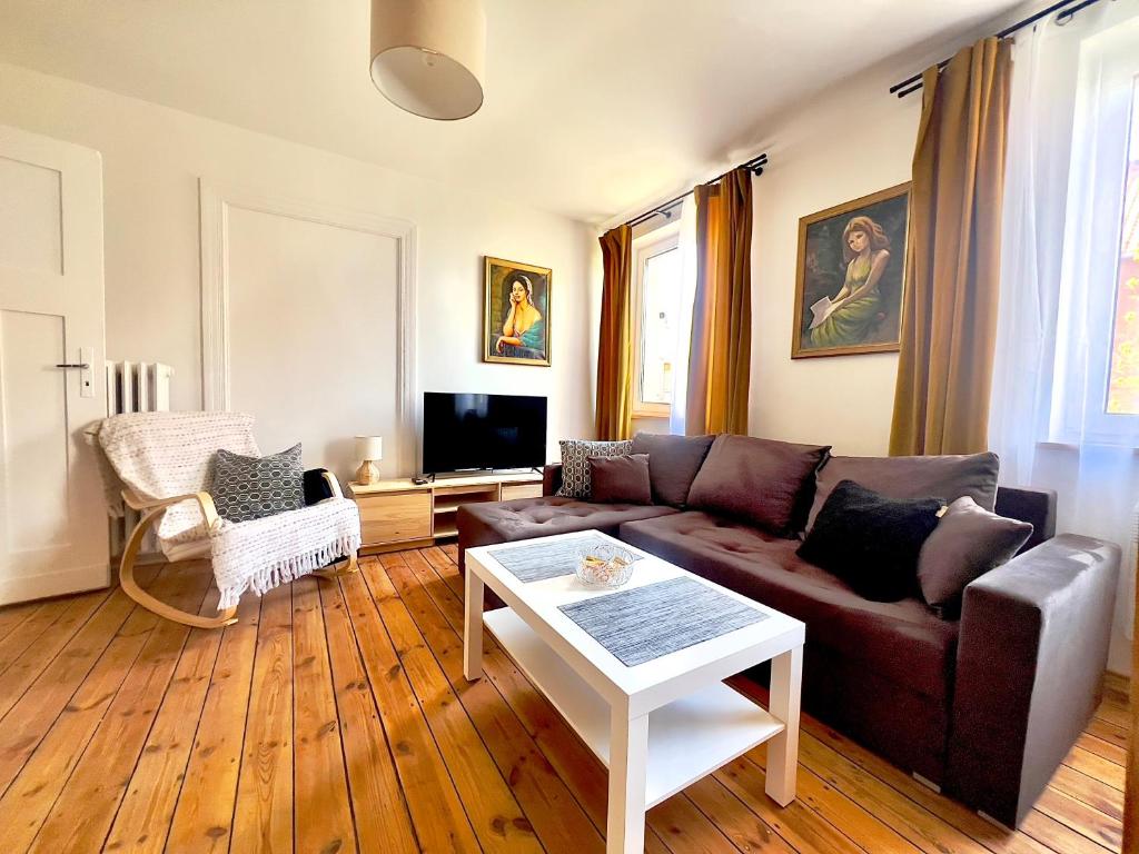 a living room with a couch and a table at Apartament Świętojański in Tolkmicko