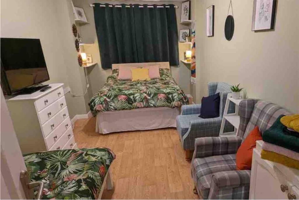 a small room with a bed and a couch at Lovely Comfortable Available in Hereford in Hereford