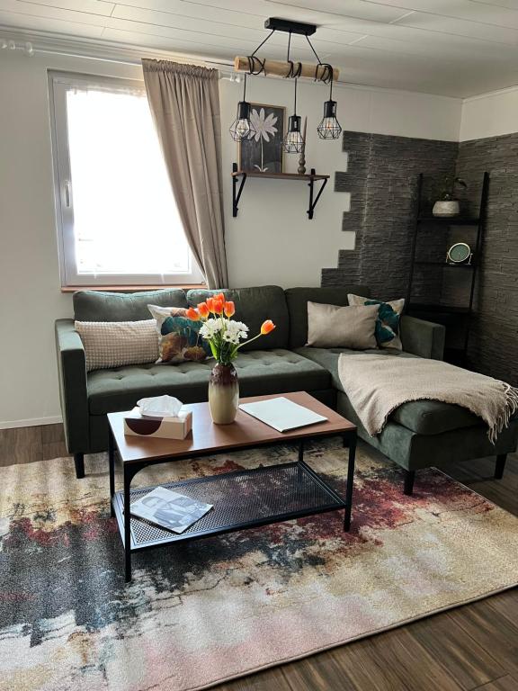 a living room with a couch and a coffee table at Ferienhaus Luunsche Landpause in Lunow