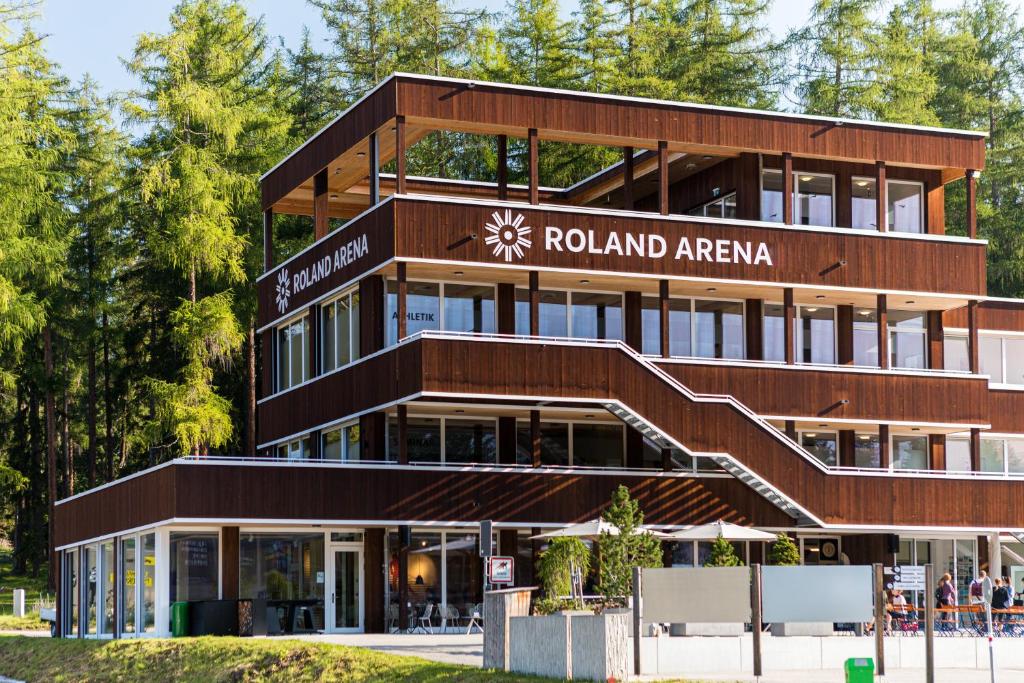 a brown building with a sign for roteland arena at Nordic Hostel in Lenz