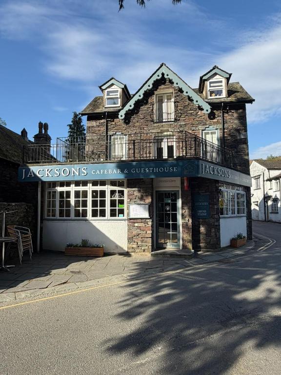 a building with a sign that reads jacksonons contingency contingency services at Jacksons CafeBar & Guesthouse in Grasmere