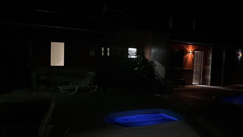 a dark yard with a blue object in the dark at Hotel Club Resort Místico in Coroaci