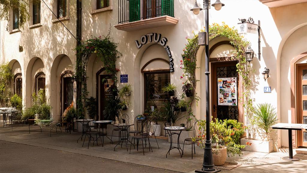 a restaurant with tables and chairs outside of a building at Lotus Home Cafe in Phú Quốc