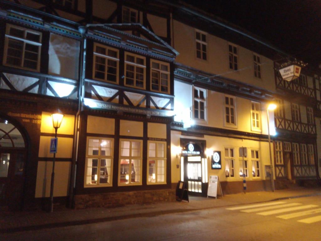 a couple of buildings on a street at night at Hotel Corveyer Hof in Höxter