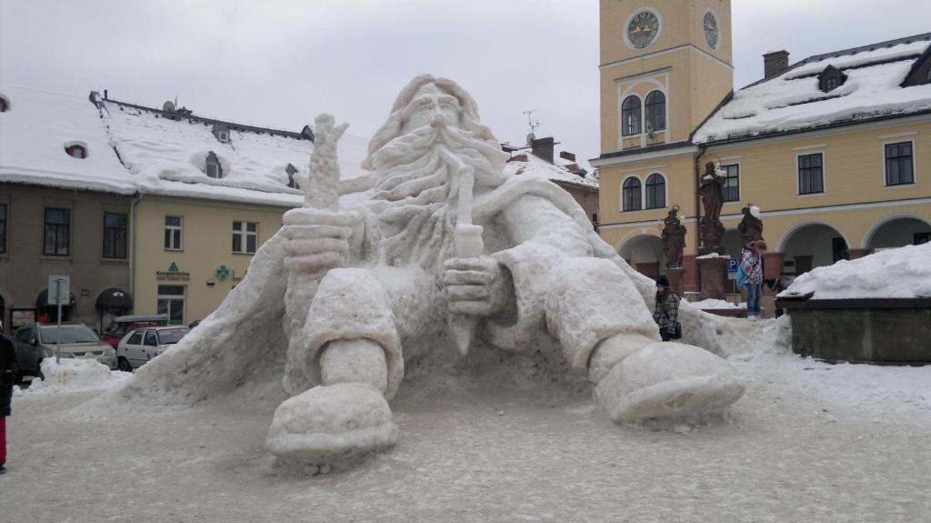 a sand sculpture of a building with a clock tower at Apartmány Kuřátko in Benecko