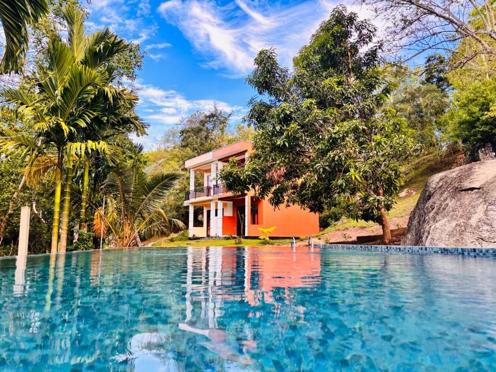 a house with a swimming pool next to a resort at Stone Garden in Dickwella