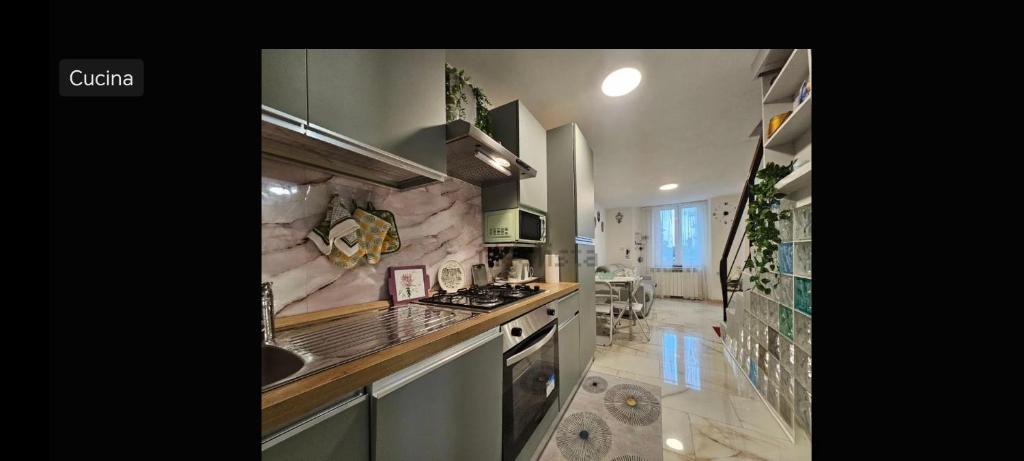 a kitchen with a sink and a stove top oven at Casetta sul mare in Savona