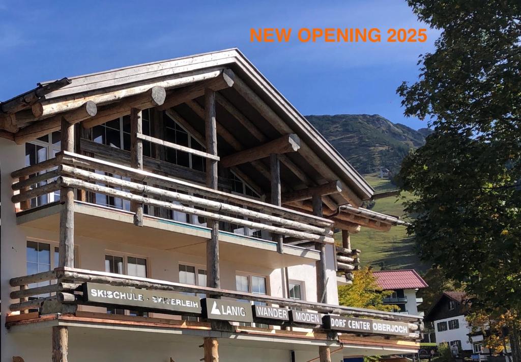 a building with a sign on the side of it at MOUNTAIN LODGE OBERJOCH - Allgäu in Bad Hindelang