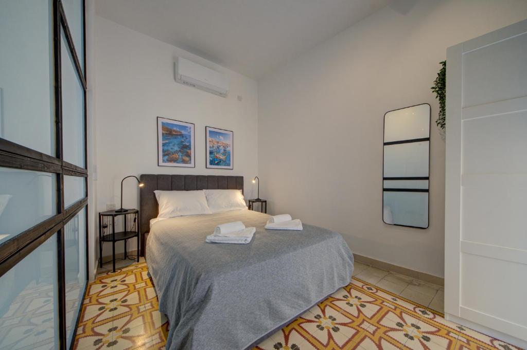 a bedroom with a bed with two towels on it at The Secret - R5 in Senglea