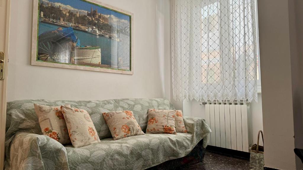 a living room with a couch with pillows at A Due Onde, Viola Mare in Alassio
