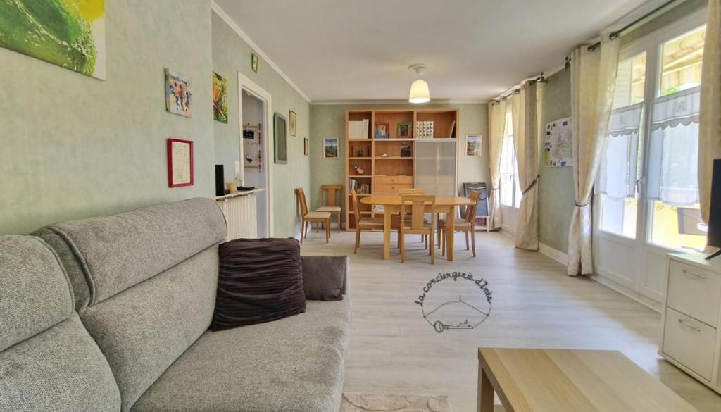 a living room with a couch and a table at Vir'Volcans - Terrasse Parking Garage privatif in Romagnat