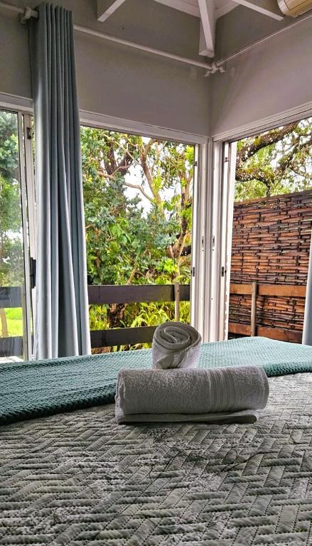 a bed with a pillow on the floor with a mirror at Daniel's Sunset Garden in Richards Bay