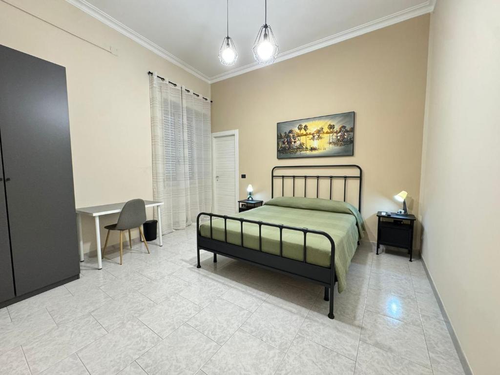 a bedroom with a bed and a table and a desk at B&B International in Saviano